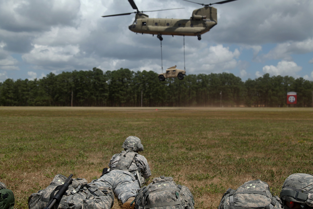 Checking the load Paratroopers watch as a M1151 Humvee is airlifted by a CH-47 Chinook Helicopter at Fort Bragg, N.C.