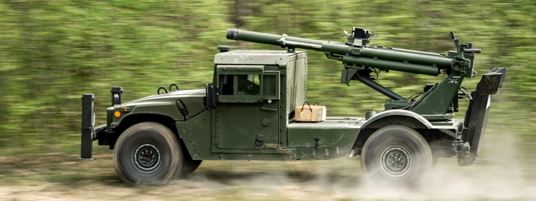 AM General's Humvee Hawkeye, Mobile Howitzer speeds by on an off-road trail