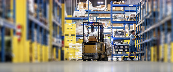 Forklift operates in an AM General aftermarket parts warehouse